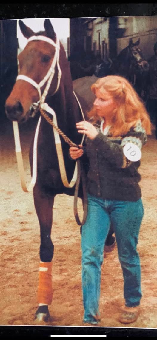 Judy as a young girl leading a horse